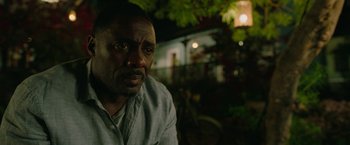 Movie still from “Beast” (2022), directed by Baltasar Kormákur – A person with a bicycle in the background; Close Up shot, Over the shoulder angle