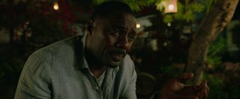 Movie still from “Beast” (2022), directed by Baltasar Kormákur – A person sitting down with his eyes wide open; Close Up shot, Over the shoulder angle