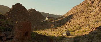 Movie still from “Beast” (2022), directed by Baltasar Kormákur – A car is parked in the middle of the desert; Extreme Wide shot, Low angle