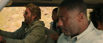 Movie still from “Beast” (2022), directed by Baltasar Kormákur – A group of people sitting in the back of a vehicle; Close Up shot, Over the shoulder angle