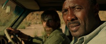 Movie still from “Beast” (2022), directed by Baltasar Kormákur – Two men in the back of a truck; Close Up shot, Over the shoulder angle