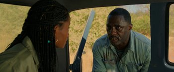 Movie still from “Beast” (2022), directed by Baltasar Kormákur – A man and a woman in the back seat of a car; Close Up shot, Over the shoulder angle