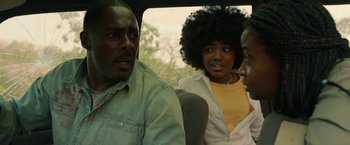 Movie still from “Beast” (2022), directed by Baltasar Kormákur – A man and two women sitting in the back of a car; Close Up shot, Over the shoulder angle