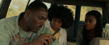 Movie still from “Beast” (2022), directed by Baltasar Kormákur – A man and a woman looking at a cell phone; Close Up shot, Low angle