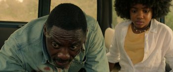 Movie still from “Beast” (2022), directed by Baltasar Kormákur – A person sitting down with his eyes wide open; Close Up shot, Over the shoulder angle