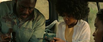Movie still from “Beast” (2022), directed by Baltasar Kormákur – A man and a woman sitting in a car looking at a cell phone; Close Up shot, Over the shoulder angle