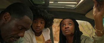Movie still from “Beast” (2022), directed by Baltasar Kormákur – Two women and a man in the back seat of a car; Close Up shot, Low angle