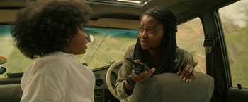 Movie still from “Beast” (2022), directed by Baltasar Kormákur – Two people in a car talking to each other; Close Up shot, Over the shoulder angle