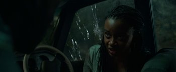 Movie still from “Beast” (2022), directed by Baltasar Kormákur – A woman sitting in the driver's seat of a car; Close Up shot, Over the shoulder angle