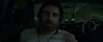 Movie still from “Beast” (2022), directed by Baltasar Kormákur – A person wearing a white shirt; Close Up shot, Low angle