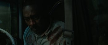 Movie still from “Beast” (2022), directed by Baltasar Kormákur – A man with blood all over his face and neck; Close Up shot, High angle