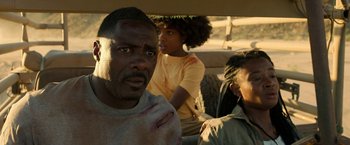 Movie still from “Beast” (2022), directed by Baltasar Kormákur – A group of people sitting in the back of a vehicle; Close Up shot, Over the shoulder angle
