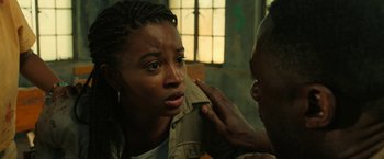 Movie still from “Beast” (2022), directed by Baltasar Kormákur – A woman is looking at a man's ear; Close Up shot, Over the shoulder angle