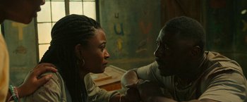 Movie still from “Beast” (2022), directed by Baltasar Kormákur – A man and a woman sitting in a room; Close Up shot, High angle