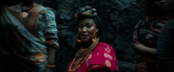 Movie still from “Beast” (2022), directed by Baltasar Kormákur – A woman in a colorful dress and a head scarf; Close Up shot, Over the shoulder angle