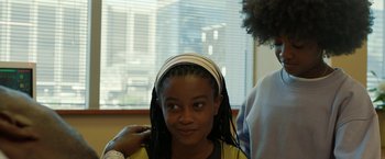Movie still from “Beast” (2022), directed by Baltasar Kormákur – A young girl is getting her hair combed; Medium shot, Over the shoulder angle