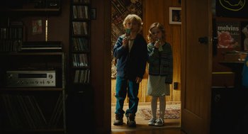 Movie still from “Beautiful Boy” (2018), directed by Felix van Groeningen – Two children are standing in a room and one of them is brushing their teeth; Medium shot, High angle