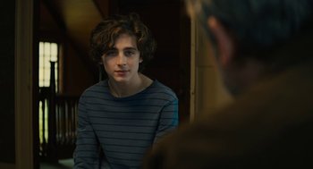 Movie still from “Beautiful Boy” (2018), directed by Felix van Groeningen – A young man sitting in front of a mirror in a room; Medium shot, Over the shoulder angle