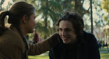 Movie still from “Beautiful Boy” (2018), directed by Felix van Groeningen – A young man smiling at a young woman's face; Close Up shot, Over the shoulder angle