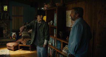 Movie still from “Beautiful Boy” (2018), directed by Felix van Groeningen – Two men standing in front of a book shelf; Medium shot, Over the shoulder angle
