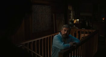 Movie still from “Beautiful Boy” (2018), directed by Felix van Groeningen – A man sitting on top of a wooden railing next to stairs; Medium shot, Low angle