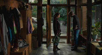 Movie still from “Beautiful Boy” (2018), directed by Felix van Groeningen – A man and a woman standing in front of an open door; Wide shot, Over the shoulder angle
