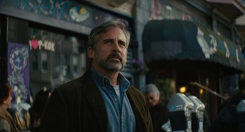 Movie still from “Beautiful Boy” (2018), directed by Felix van Groeningen – A man standing in front of a building in a city; Close Up shot, Low angle