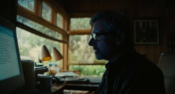 Movie still from “Beautiful Boy” (2018), directed by Felix van Groeningen – A man sitting in front of a desk with a lamp; Close Up shot, Low angle