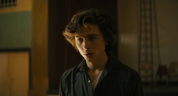 Movie still from “Beautiful Boy” (2018), directed by Felix van Groeningen – A young man in a black shirt is looking at the camera; Close Up shot, Low angle