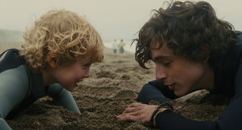 Movie still from “Beautiful Boy” (2018), directed by Felix van Groeningen – Two young people laying in the sand on the beach; Close Up shot, Over the shoulder angle