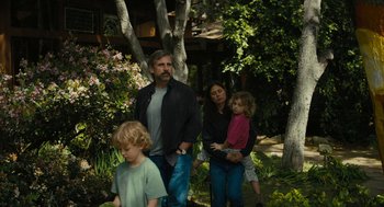 Movie still from “Beautiful Boy” (2018), directed by Felix van Groeningen – A man and a woman and two children standing in a garden; Wide shot, High angle