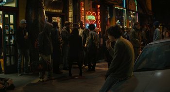 Movie still from “Beautiful Boy” (2018), directed by Felix van Groeningen – A group of people standing on the sidewalk at night; Wide shot, High angle