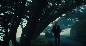 Movie still from “Beautiful Boy” (2018), directed by Felix van Groeningen – A man standing next to a tree on the side of a road; Wide shot, Low angle