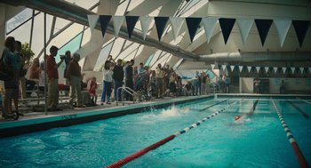 Movie still from “Beautiful Boy” (2018), directed by Felix van Groeningen – A group of people standing around a swimming pool; Extreme Wide shot, High angle