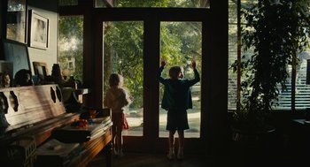 Movie still from “Beautiful Boy” (2018), directed by Felix van Groeningen – Two young children standing in front of an open door; Wide shot, Over the shoulder angle
