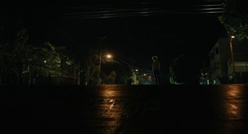 Movie still from “Beautiful Boy” (2018), directed by Felix van Groeningen – A person standing on the side of a road at night; Extreme Wide shot, Low angle