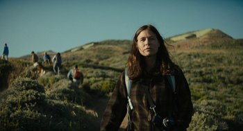 Movie still from “Beautiful Boy” (2018), directed by Felix van Groeningen – A woman with a camera standing on top of a hill; Medium shot, Low angle