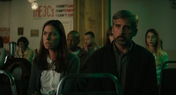 Movie still from “Beautiful Boy” (2018), directed by Felix van Groeningen – A man and a woman sitting next to each other on a bus; Medium shot, Low angle