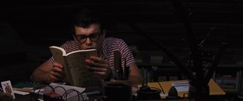 Movie still from “Beautiful Creatures” (2013), directed by Richard LaGravenese – A man reading a book in a dark room; Medium shot, High angle