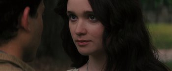 Movie still from “Beautiful Creatures” (2013), directed by Richard LaGravenese – A woman's face with a chain around her neck; Close Up shot, Over the shoulder angle