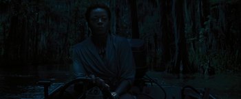 Movie still from “Beautiful Creatures” (2013), directed by Richard LaGravenese – A person sitting in a chair in the dark; Medium shot, High angle