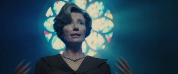 Movie still from “Beautiful Creatures” (2013), directed by Richard LaGravenese – An older woman wearing a necklace in front of a stained glass window; Close Up shot, Low angle