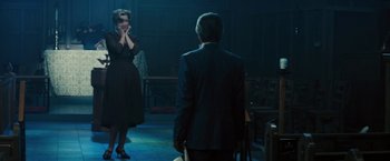 Movie still from “Beautiful Creatures” (2013), directed by Richard LaGravenese – A man and a woman standing in a dark room; Medium shot, Over the shoulder angle
