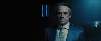 Movie still from “Beautiful Creatures” (2013), directed by Richard LaGravenese – A man in a suit and tie standing in front of a window; Close Up shot, Over the shoulder angle