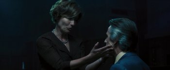 Movie still from “Beautiful Creatures” (2013), directed by Richard LaGravenese – A woman and a man in a dark room touching hands; Close Up shot, Over the shoulder angle