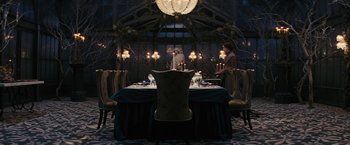 Movie still from “Beautiful Creatures” (2013), directed by Richard LaGravenese – A dining room table set for a meal with candles lit up; Wide shot, High angle