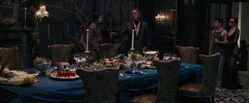 Movie still from “Beautiful Creatures” (2013), directed by Richard LaGravenese – A man and a woman standing in front of a dinner table; Wide shot, Over the shoulder angle