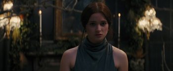 Movie still from “Beautiful Creatures” (2013), directed by Richard LaGravenese – A young woman with long red hair wearing a gray dress; Close Up shot, Over the shoulder angle