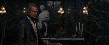 Movie still from “Beautiful Creatures” (2013), directed by Richard LaGravenese – A man standing in front of a statue in the dark; Medium shot, Over the shoulder angle