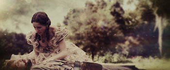 Movie still from “Beautiful Creatures” (2013), directed by Richard LaGravenese – A woman sitting on the side of a road; Medium shot, High angle